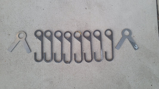 8 AR500 steel gong hooks and 2 stand ends laid out on concrete