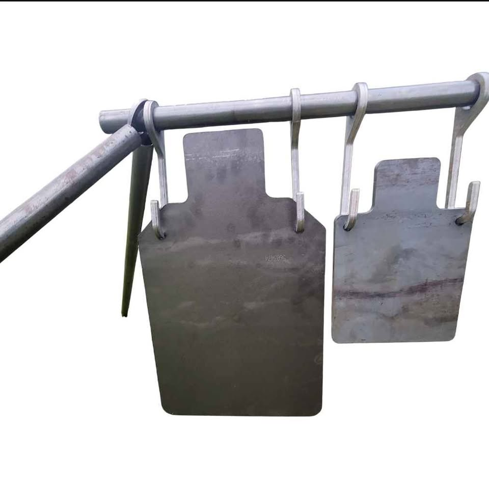 AR500 steel targets hanging from gong hooks on a pipe stand